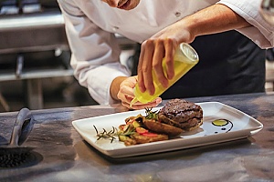 a chef at a new restaurant receiving tips on how to make the best marinated steak